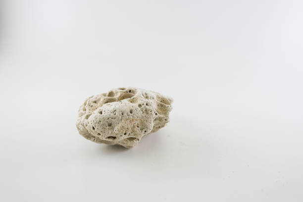 istock Boulder shape with a surface of national erosion on a white back 1411455635