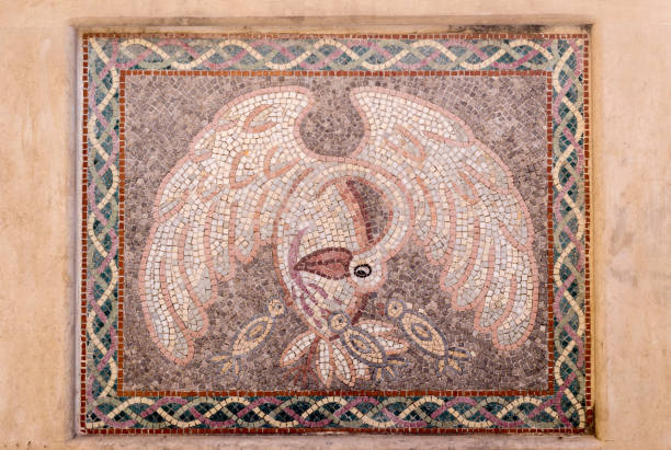 Old stone mosaic on a Christian, Orthodox, monastery yard close-up (Corfu island, Greece).