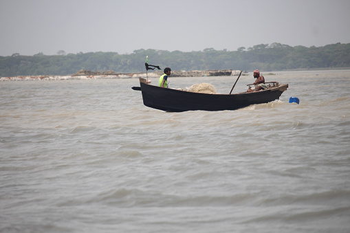 17-Apr-22 Babuganj, Barisal, Bangladesh.Small fishing boats are floating in the river.
