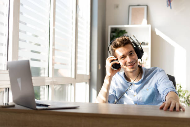 istock Smiling. young customer support operator with hands-free headset working in the office. 1411457135