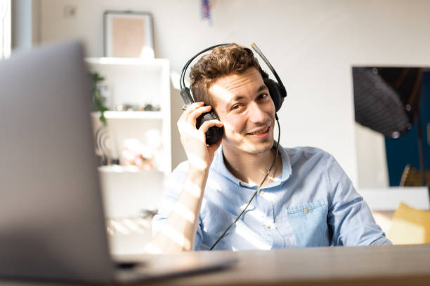 istock Smiling. young customer support operator with hands-free headset working in the office. 1411457209