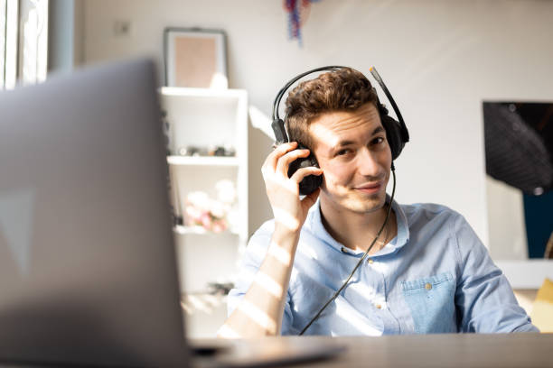 istock Smiling. young customer support operator with hands-free headset working in the office. 1411457210