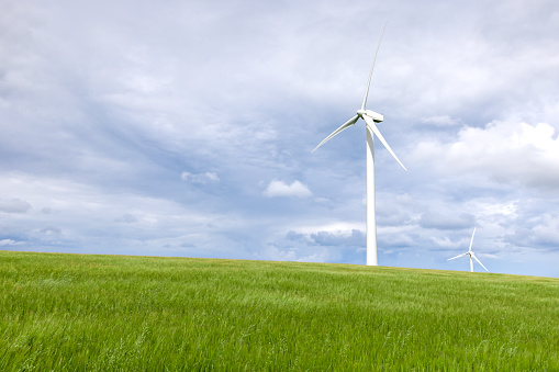 Onshore wind turbine with green grass foreground