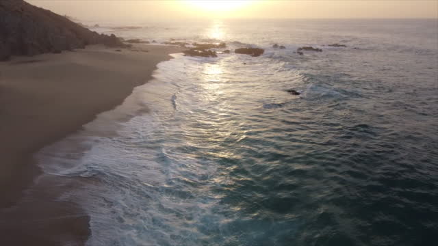 Aerial View Cabo, Mexico shoreline and beach during sunset