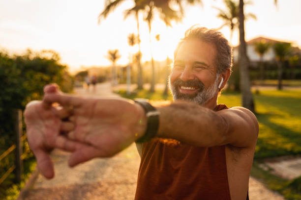 istock Active senior man stretching outside, preparing for a run. 1411457816