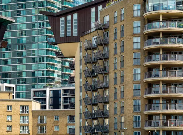 Sections of apartment blocks next to the office skyscrapers at Canary Wharf on the Isle of Dogs in London’s Docklands.