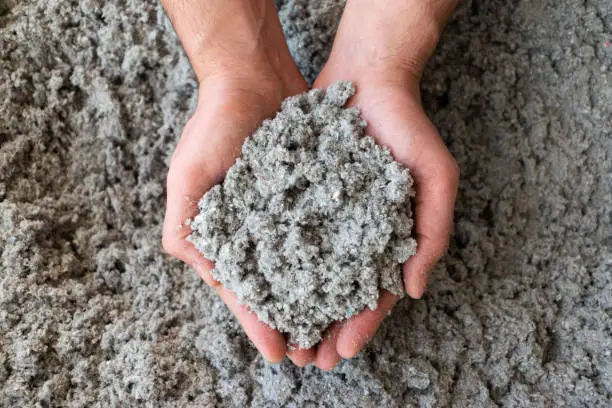 Photo of Close shot of eco friendly cellulose insulation filling held in hand