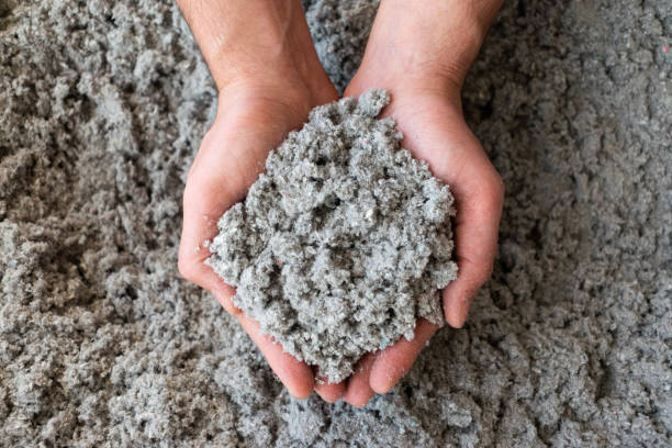 close shot of eco friendly cellulose insulation filling held in hand - white green colors paper imagens e fotografias de stock