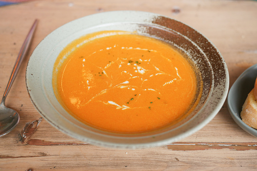 a bowl of tomato vegetables soup in a bowl on table ,
