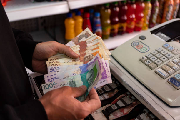 istock Men's hands with Colombian Pesos 1411465021