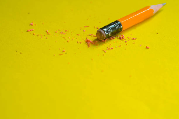 istock Eraser and pencil on fresh yellow paper 1411466269
