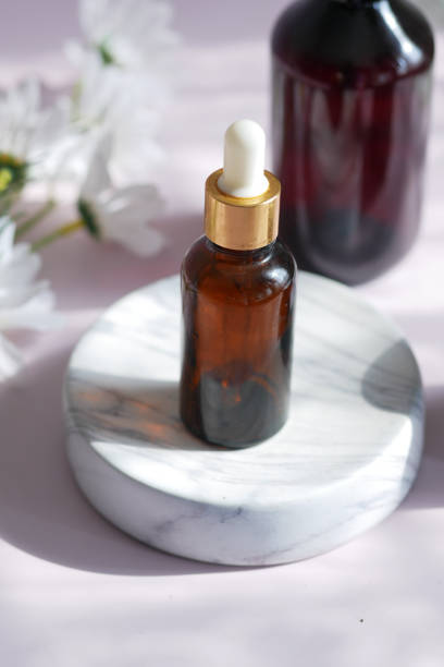 istock eucalyptus essential oils in a glass bottle and flower on table 1411468771