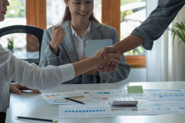 istock Company representatives join hands to work together on real estate projects and make profits for the company. 1411470268