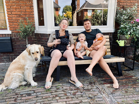 Young family with just born twin, toddler daughter and there dog.