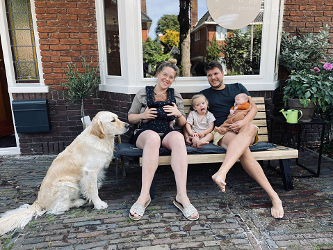 Young family with just born twin, toddler daughter and there dog.