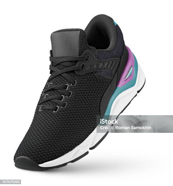 Black Sneaker Stands On The Tip Isolated On White Stock Photo - Download Image Now - Sports Shoe, Canvas Shoe, White Background