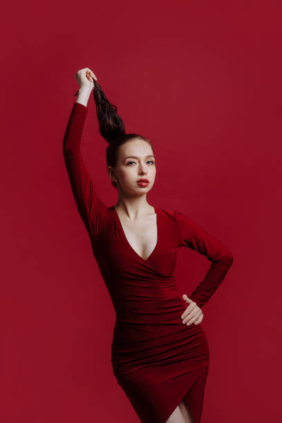 istock Sensual beautiful brunette posing in a red dress. 1411475507