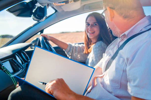 istock Young Woman driver taking driving test 1411476669