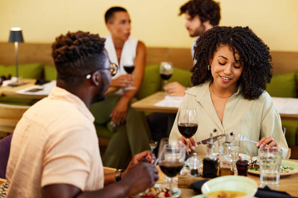 istock A happy multiracial couple sits in a restaurant, chatting and having dinner together. 1411477010
