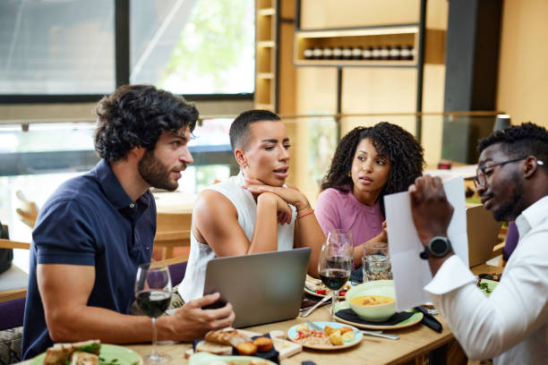 istock Businesspeople sit at the dinner table in a restaurant and brainstorm about a start-up project. 1411477839
