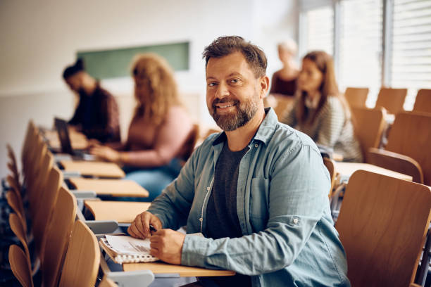 istock Happy mature man attending a class at the university and looking at camera. 1411477946
