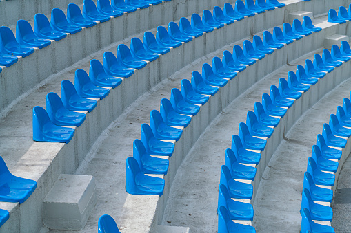 Blue stadium seats in a frontal view.