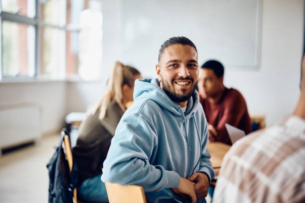 istock Happy male student attending a class at the university and looking at camera. 1411478225