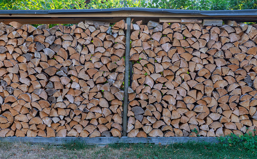 Firewood outdoor storage - wooden logs stacked