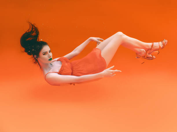 surreal, concept, art, orange, abstract, futuristic ultraviolet pattern of beautiful young woman underwater in negative style surreal, concept, art, orange, abstract, futuristic ultraviolet pattern of beautiful young woman underwater in negative style crazy makeup stock pictures, royalty-free photos & images
