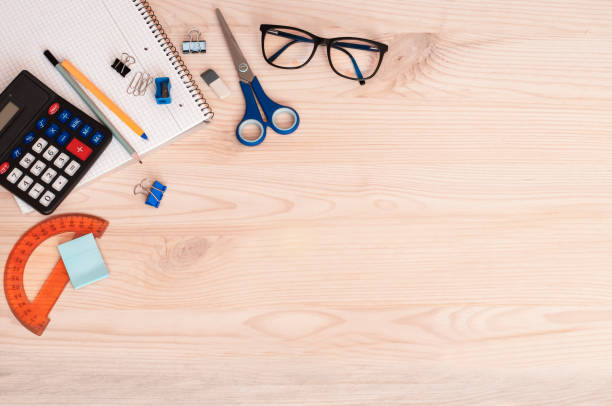 istock training, notebook, calculator lie on a wooden table with space for text 1411482070