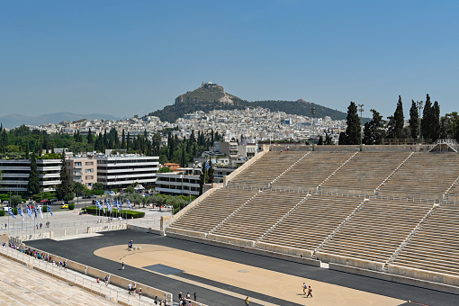 Athens, Greece - Jul 13, 2019: Symmetrical view of empty Panathenaic Stadium from the audience on sunny day. Panathenaic Stadium called Kallimarmaro in Athens. Taken on mobile device.