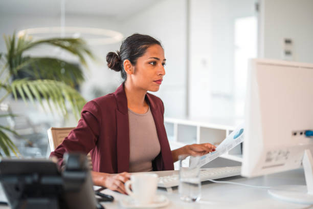 istock Beautiful Asian Young Woman Working And Using a Computer 1411482447