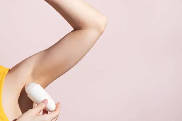 Lady Applying Antiperspirant Roll Underarms For Armpits Freshness. High quality photo