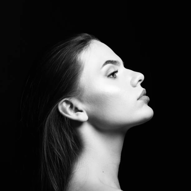 istock Beautiful woman studio portrait in black background 1411484001