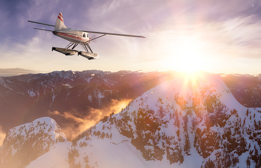 Single Engine Seaplane Flying over the Rocky Mountain Landscape. Sunset Sky. Adventure Composite. 3D Rendering Plane. Aerial Background from British Columbia near Vancouver, Canada.