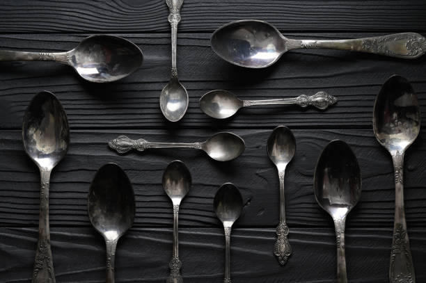istock Directly above a shot of old spoons on a black table 1411486048