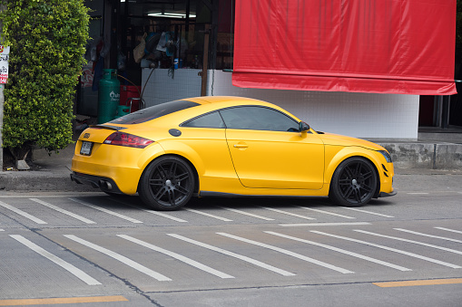 Side view of yellow Audi TT coupe parked in Bangkok Nawamin