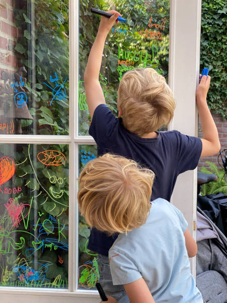 istock Family children making a window paint 1411486322