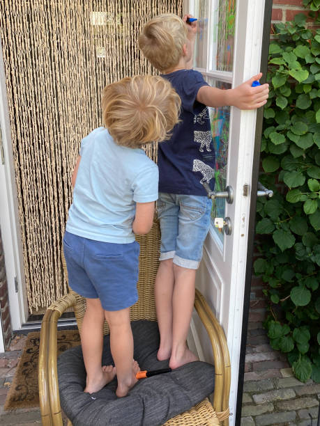 istock Family children making a window paint 1411486325