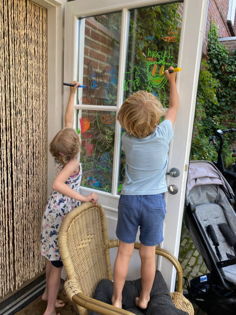 istock Family children making a window paint 1411486334