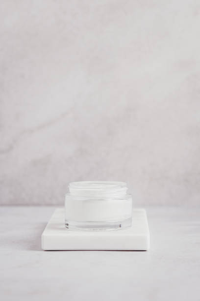 istock White blank cosmetic bottle, cream moisturizer and wheat decor for mock up on white marble tray 1411486489