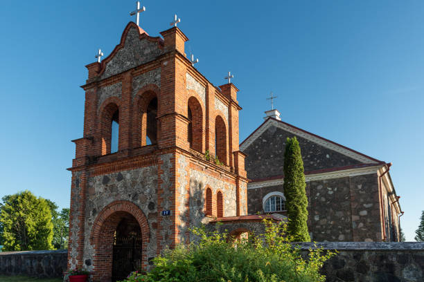 istock Subate Catholic church and bell tower in sunny summer day, Latvia 1411487529