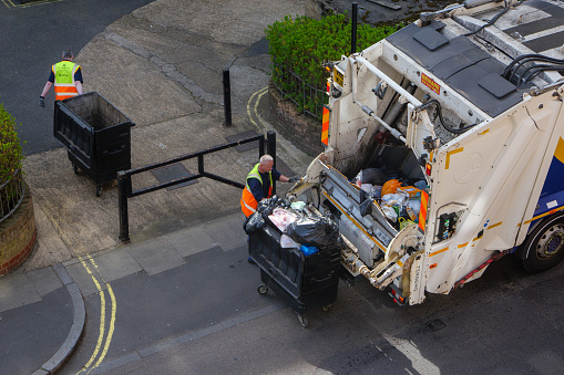 London, UK-17.04.22: a rear loader truck collecting rubbish in a City of Westminster, central London