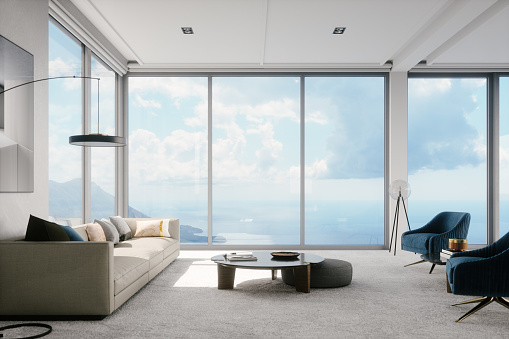 Interior of a contemporary home living room with beautiful mountain and ocean view.