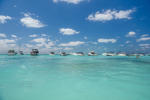 White speed boats and yachts in turquoise azure caribbean sea, Isla Mujeres island, Caribbean Sea, Cancun, Yucatan, Mexico.