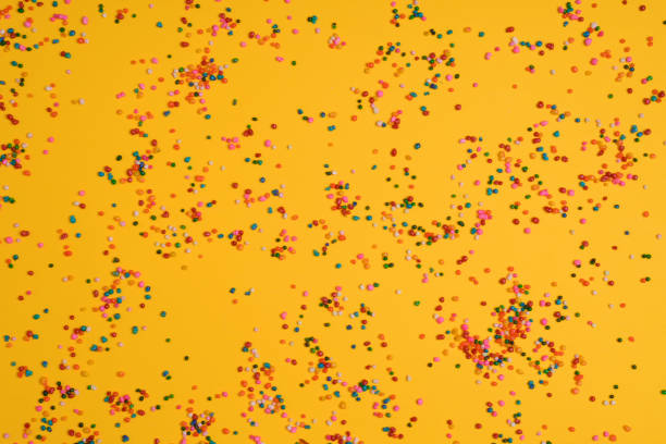istock Sugar sprinkles on yellow background 1411491754