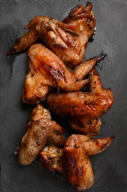 istock appetizing chicken wings grilled barbecue with spices and vegetables until crisp 1411492950