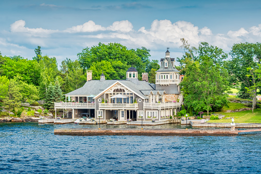 Waterfront mansion in Alexandria Bay, Thousand Islands region, New York State USA on a sunny day.