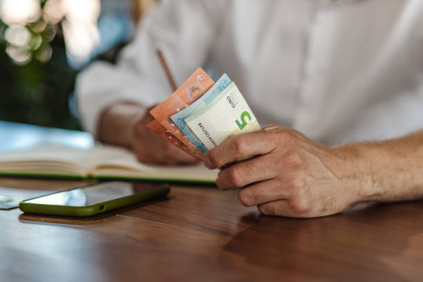 istock Young man holding money 1411496250