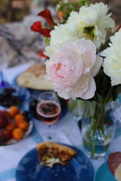 istock beautiful picnic with flowers pizza and wine 1411501071